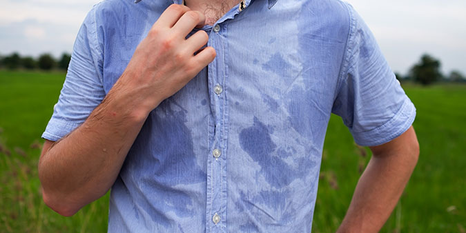 Man in blue shirt with excessive sweating