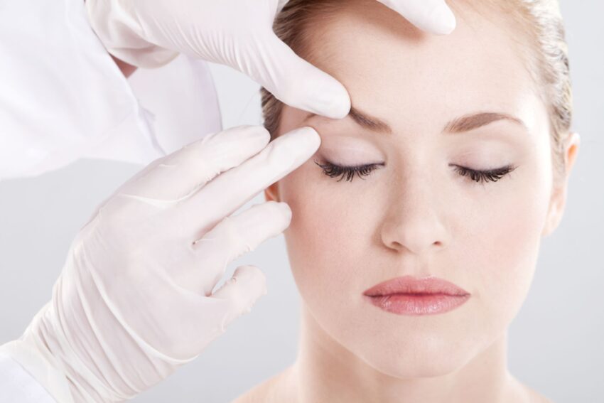 A woman being examined prior to scar filler treatment